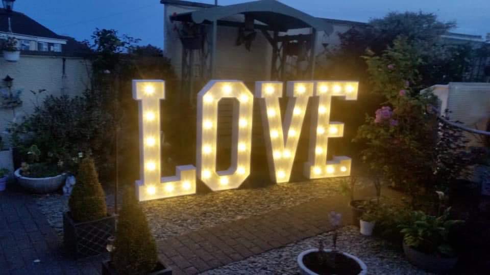 Lit wooden love letters