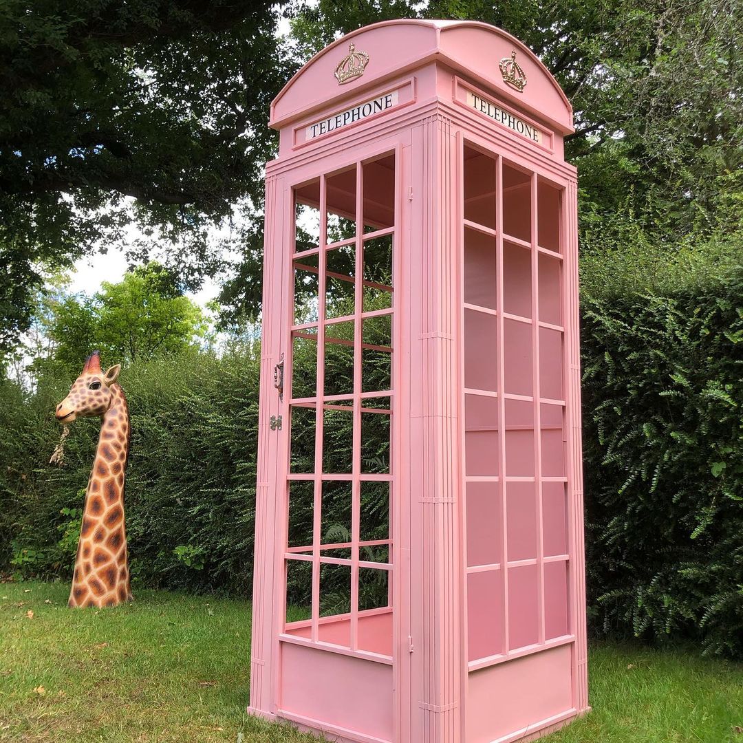 Empty Pink telephone box for hire.